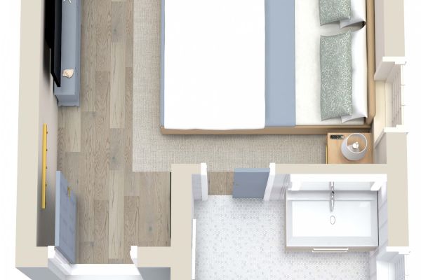 This image is a 3D floor plan showing a bedroom with a bed, side tables, a TV, and a desk, connected to a bathroom with a toilet and a shower.