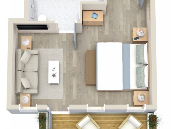The image shows a top-down view of a small apartment layout with a bedroom, living area, bathroom, and balcony with two chairs and a table.