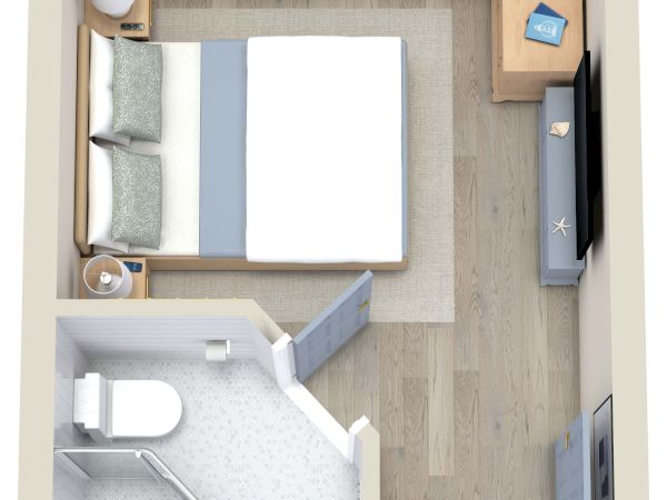 The image shows a small, furnished studio apartment with a bed, two nightstands, a TV, a dresser, and a bathroom.